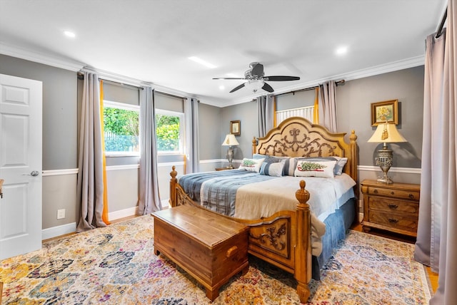 bedroom with ceiling fan and ornamental molding