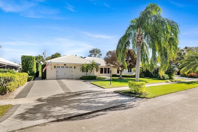 view of front of property featuring a front lawn and a garage