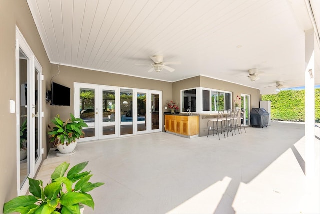 view of patio with french doors and an outdoor wet bar