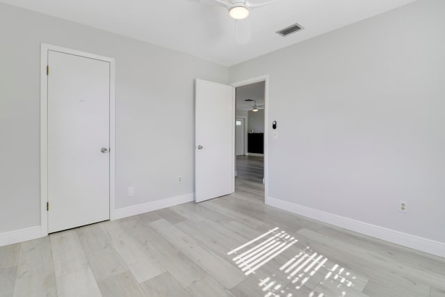 unfurnished bedroom with ceiling fan and light wood-type flooring