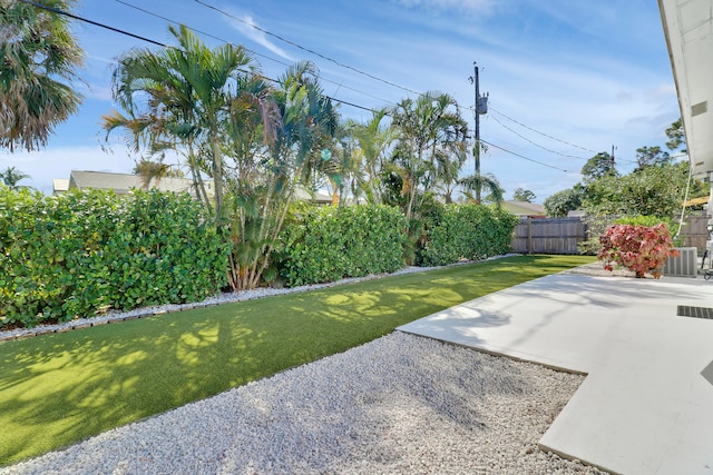 view of yard featuring cooling unit and a patio