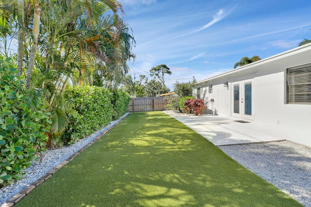 view of yard with a patio and french doors