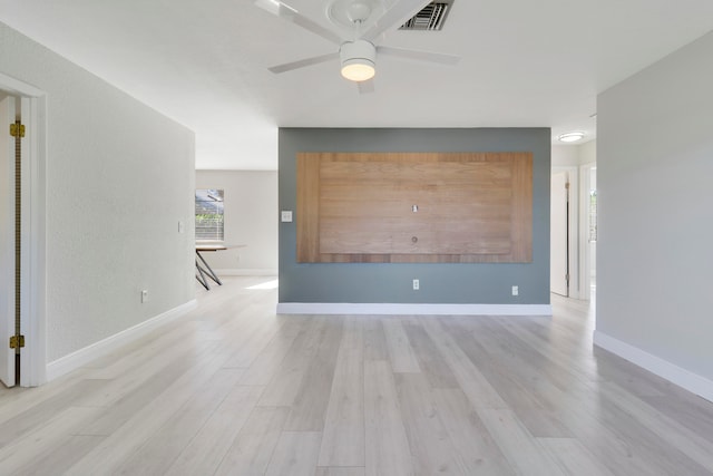 empty room featuring ceiling fan and light hardwood / wood-style floors