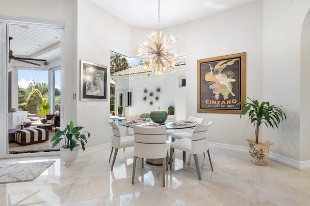 dining area featuring a high ceiling and an inviting chandelier