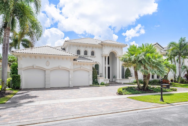 mediterranean / spanish-style home featuring a garage