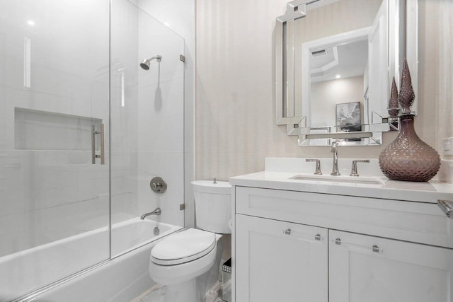 full bathroom featuring shower / bath combination with glass door, vanity, and toilet