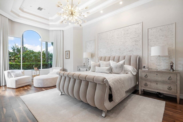 bedroom with crown molding, hardwood / wood-style floors, and an inviting chandelier