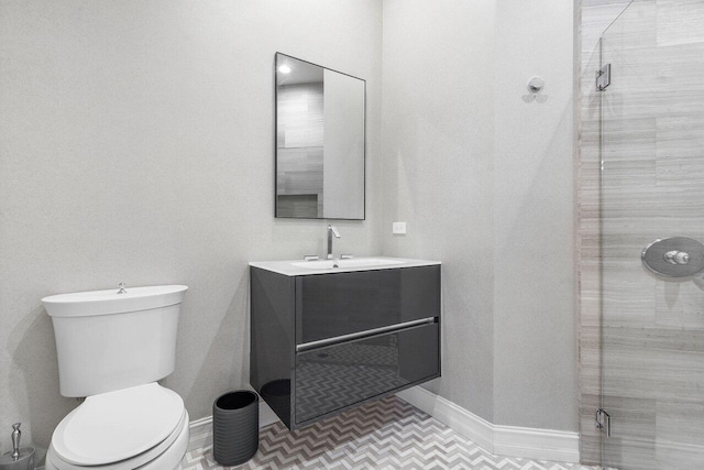 bathroom with tile patterned floors, vanity, toilet, and a shower with door