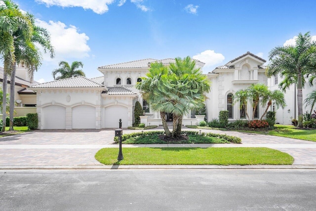 mediterranean / spanish home featuring a garage