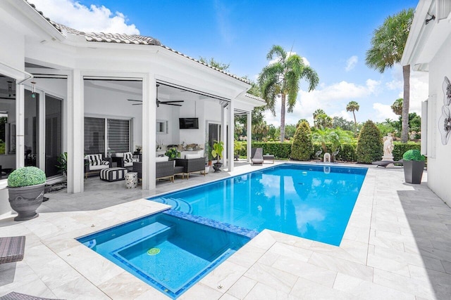 view of pool with outdoor lounge area, ceiling fan, a patio area, and an in ground hot tub