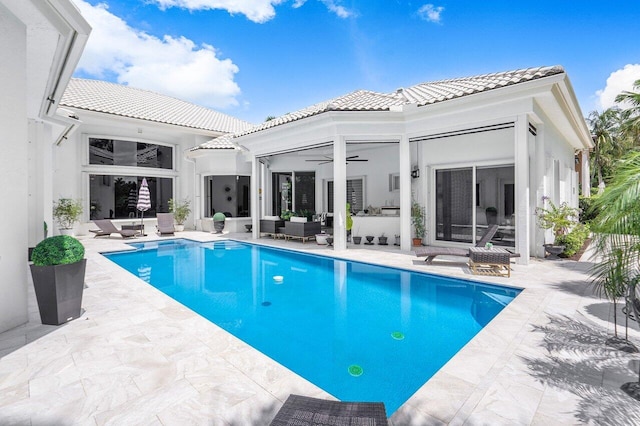 back of property with a patio area, ceiling fan, and outdoor lounge area