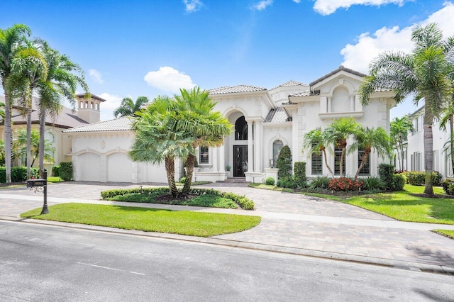 mediterranean / spanish-style house with a garage