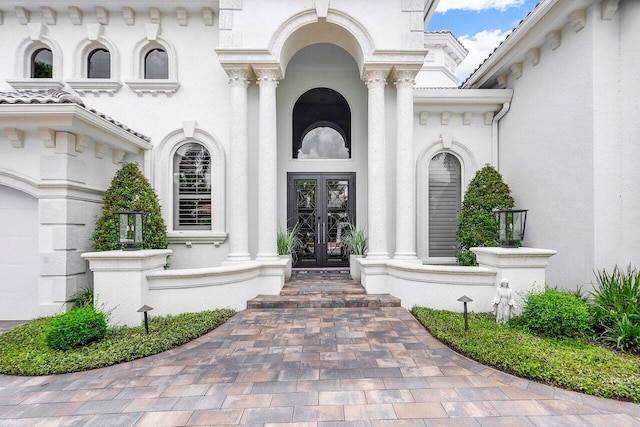 view of exterior entry featuring french doors