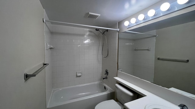 full bathroom with vanity, toilet, and tiled shower / bath