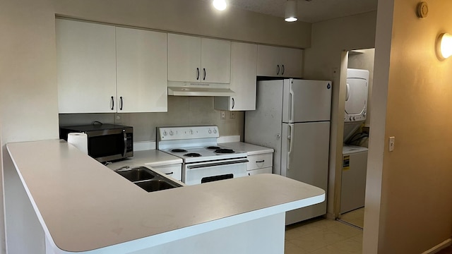 kitchen featuring white cabinets, white appliances, kitchen peninsula, and sink