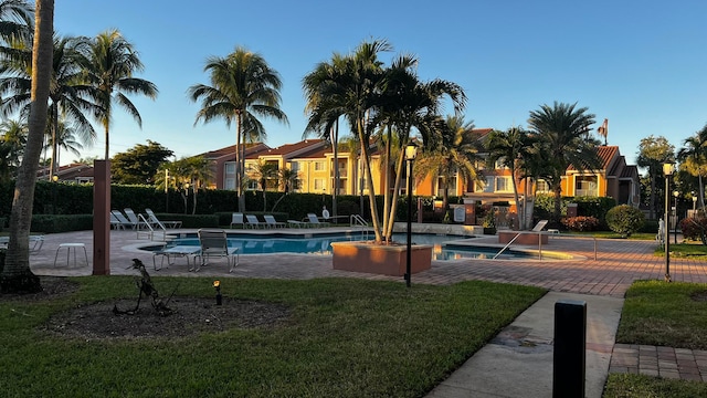 view of pool featuring a yard, a patio, and a hot tub