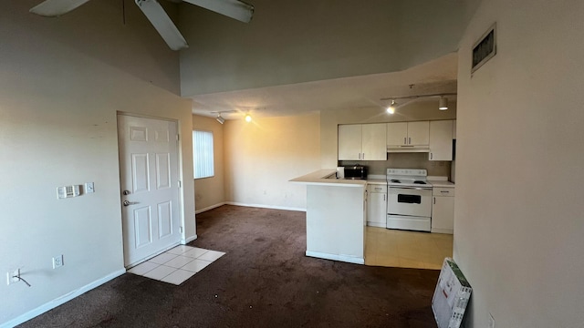 kitchen featuring track lighting, electric stove, kitchen peninsula, light colored carpet, and white cabinetry