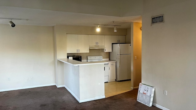 kitchen featuring white cabinetry, white appliances, carpet floors, and track lighting