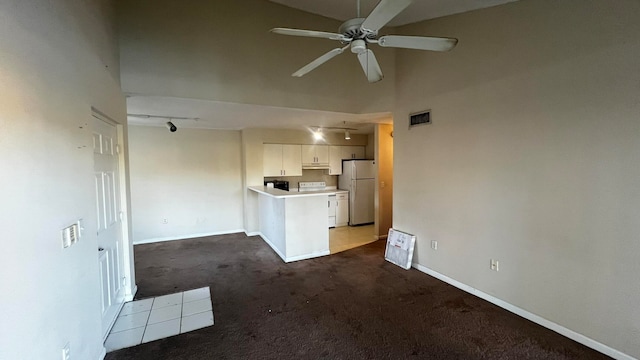 unfurnished living room featuring carpet floors, high vaulted ceiling, and ceiling fan