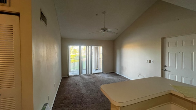 interior space with dark colored carpet, ceiling fan, and high vaulted ceiling