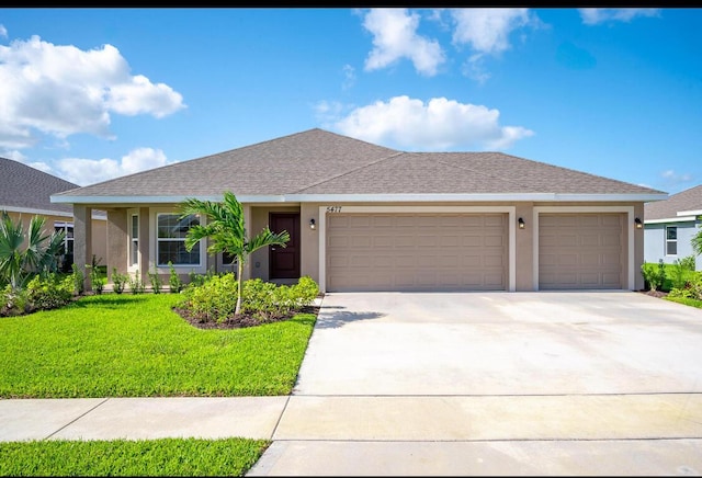 view of front of property featuring a garage and a front lawn