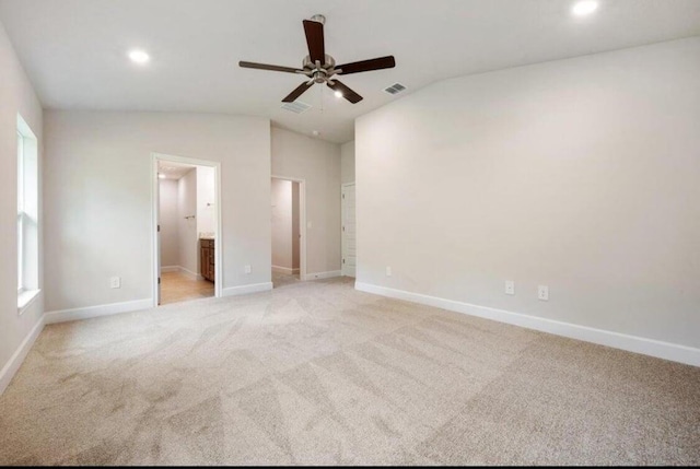 carpeted empty room featuring ceiling fan and lofted ceiling