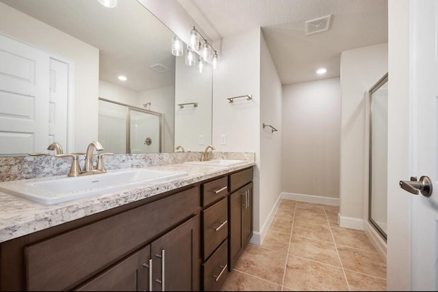 bathroom with vanity, tile patterned floors, and a shower with shower door