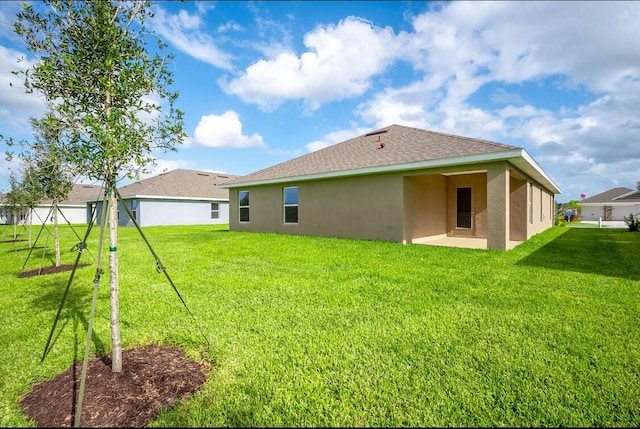 rear view of house featuring a yard