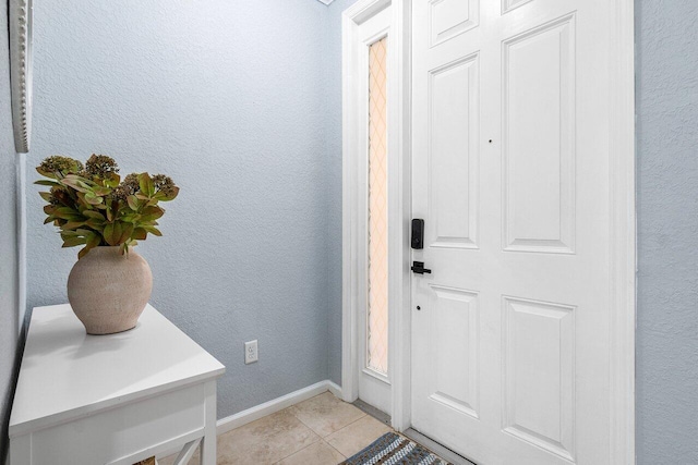 doorway to outside featuring light tile patterned floors