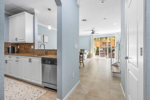 kitchen with ceiling fan, stainless steel dishwasher, sink, white cabinetry, and light tile patterned floors