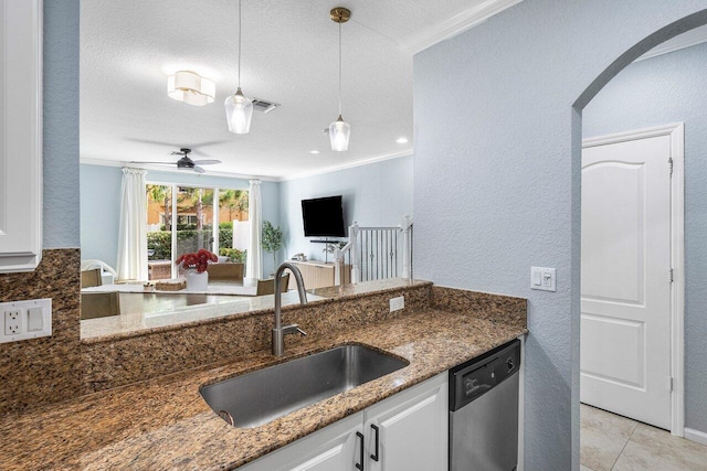 kitchen featuring pendant lighting, white cabinetry, dark stone countertops, sink, and stainless steel dishwasher