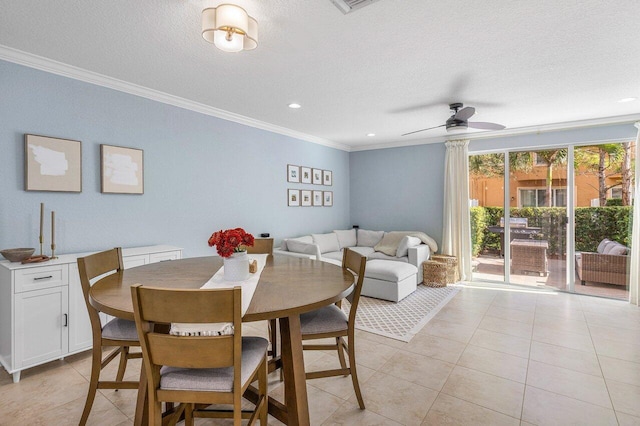 dining room with ceiling fan, crown molding, and light tile patterned flooring