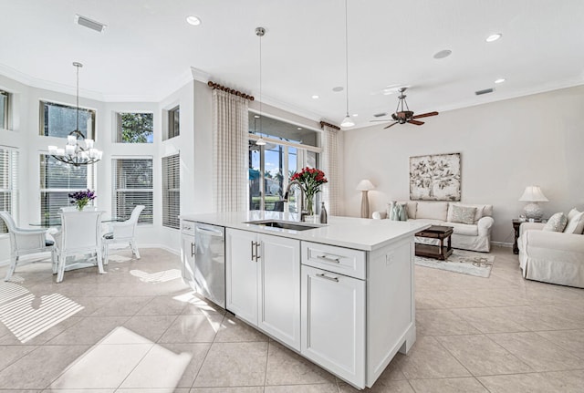 kitchen featuring sink, pendant lighting, light tile patterned floors, dishwasher, and white cabinetry