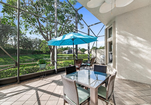 unfurnished sunroom featuring ceiling fan