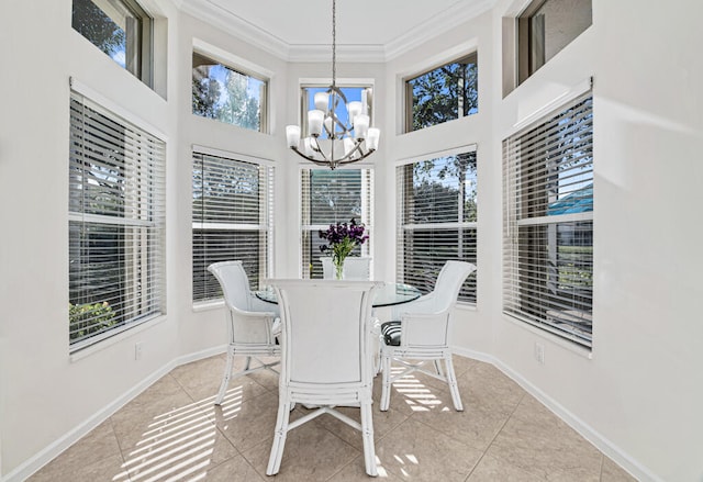 dining area featuring light tile patterned floors, crown molding, a notable chandelier, and a high ceiling