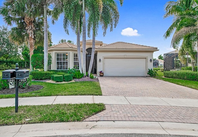 mediterranean / spanish-style home with a garage and a front lawn