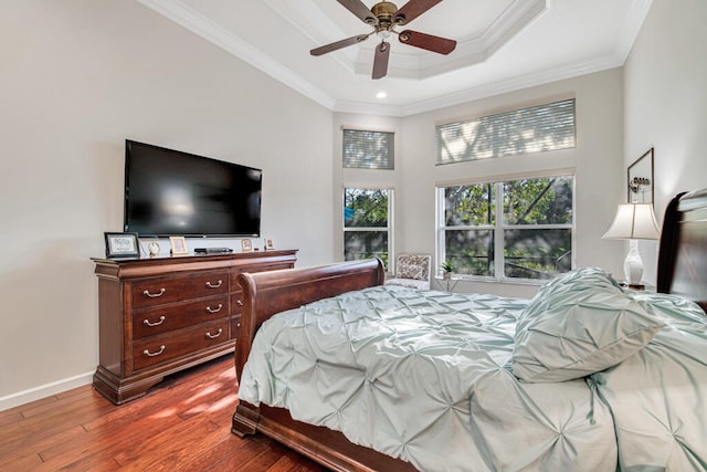 bedroom with ceiling fan, wood-type flooring, and ornamental molding