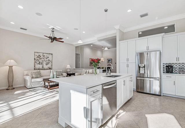 kitchen featuring appliances with stainless steel finishes, white cabinetry, pendant lighting, and sink