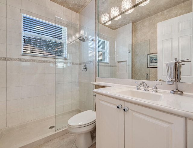 bathroom with plenty of natural light, toilet, walk in shower, and vanity