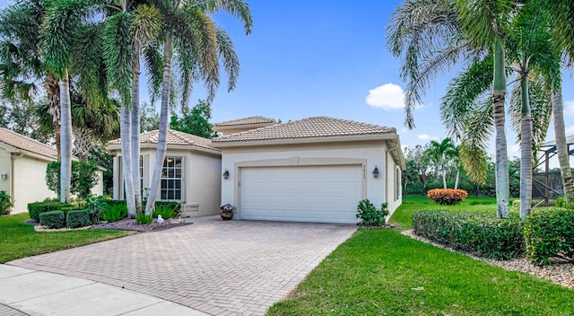 mediterranean / spanish-style house with a garage and a front yard