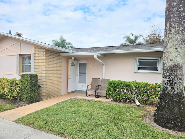 property entrance with a yard