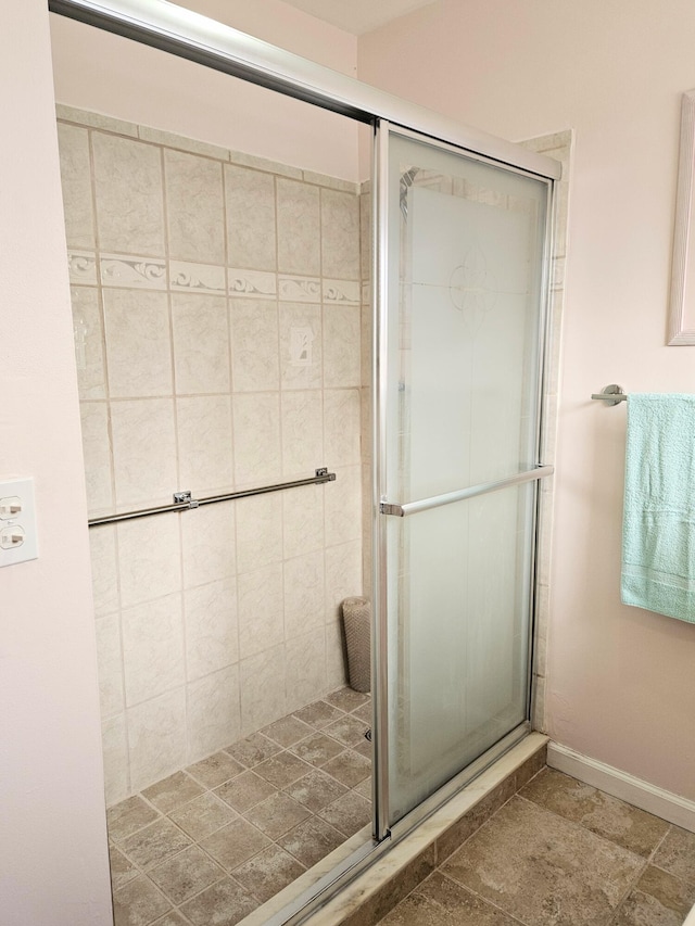 bathroom featuring a shower with door