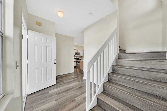 stairs with hardwood / wood-style floors