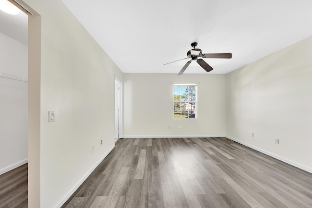 spare room featuring hardwood / wood-style floors and ceiling fan