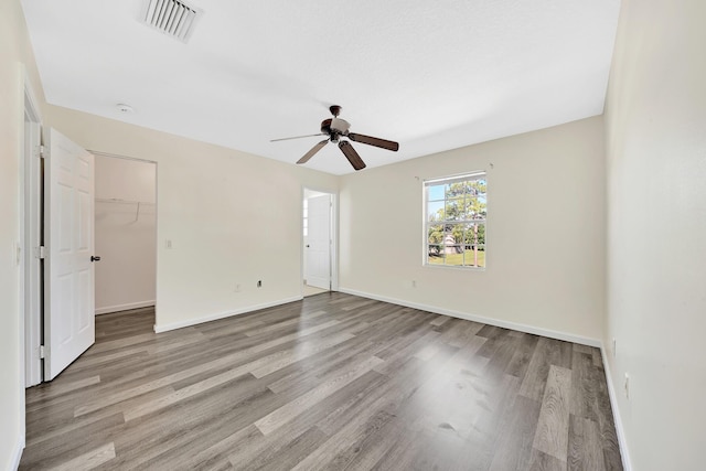 spare room with ceiling fan and light hardwood / wood-style flooring