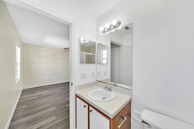 bathroom featuring hardwood / wood-style floors, vanity, and toilet