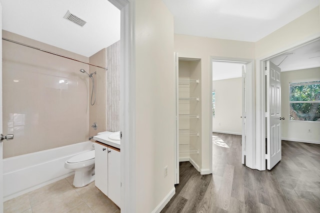 full bathroom with vanity, toilet, wood-type flooring, and tiled shower / bath