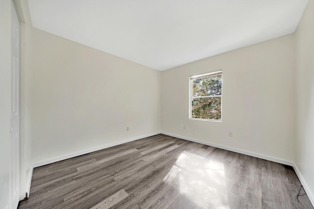 spare room with hardwood / wood-style floors