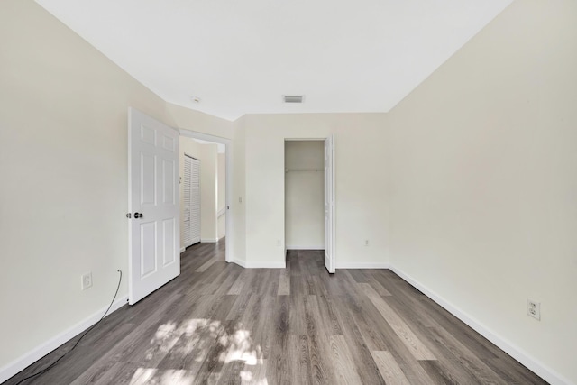 unfurnished bedroom featuring hardwood / wood-style flooring and a closet