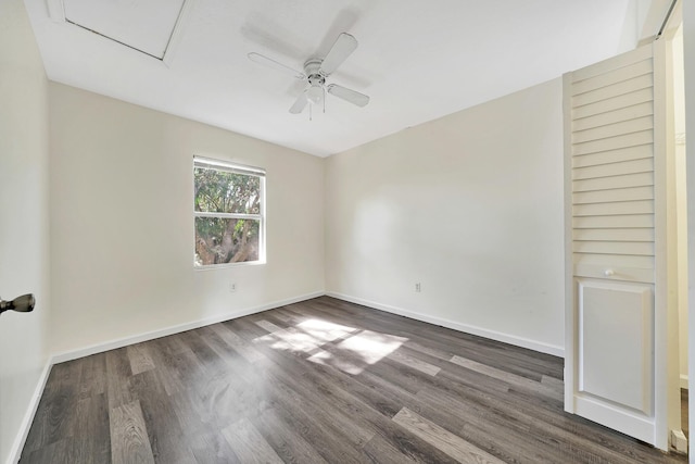 spare room with ceiling fan and dark hardwood / wood-style flooring